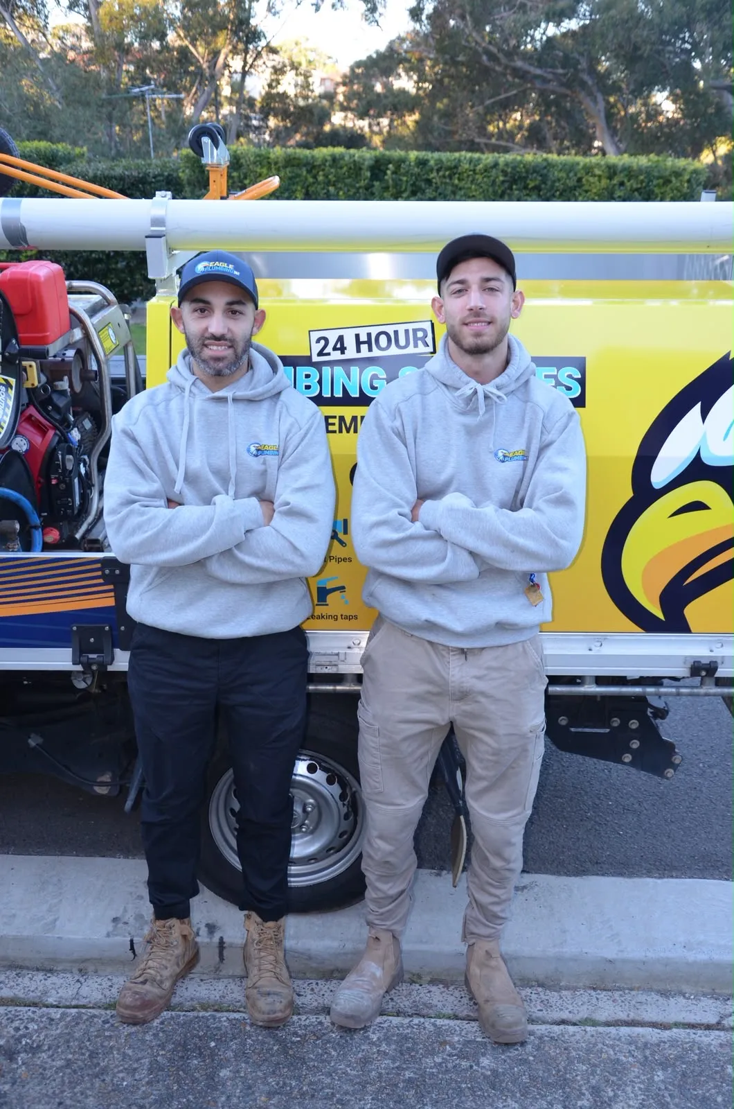Kareem and Zac, cousins and directors of Eagle Plumbing 24/7, standing in front of their branded ute